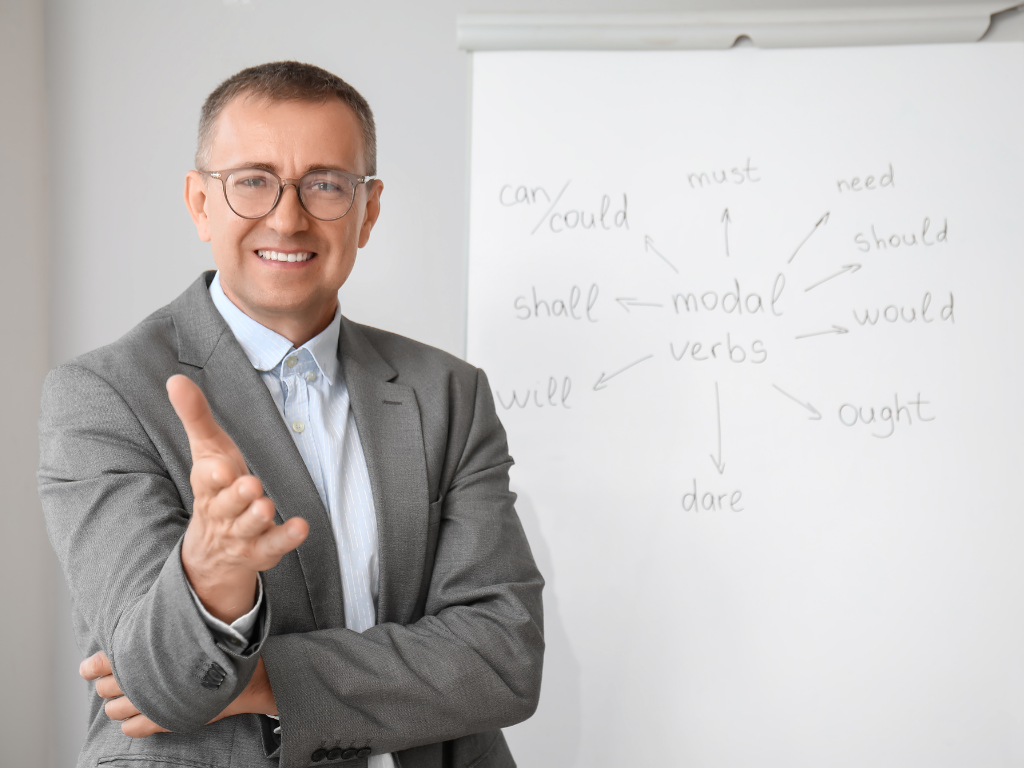 Instructor explaining Chinese grammar concepts and sentence structures on a classroom whiteboard