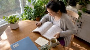 Adult woman reading Mandarin book attentively