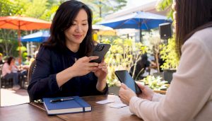 Businesswoman exchanging WeChat contacts with colleague