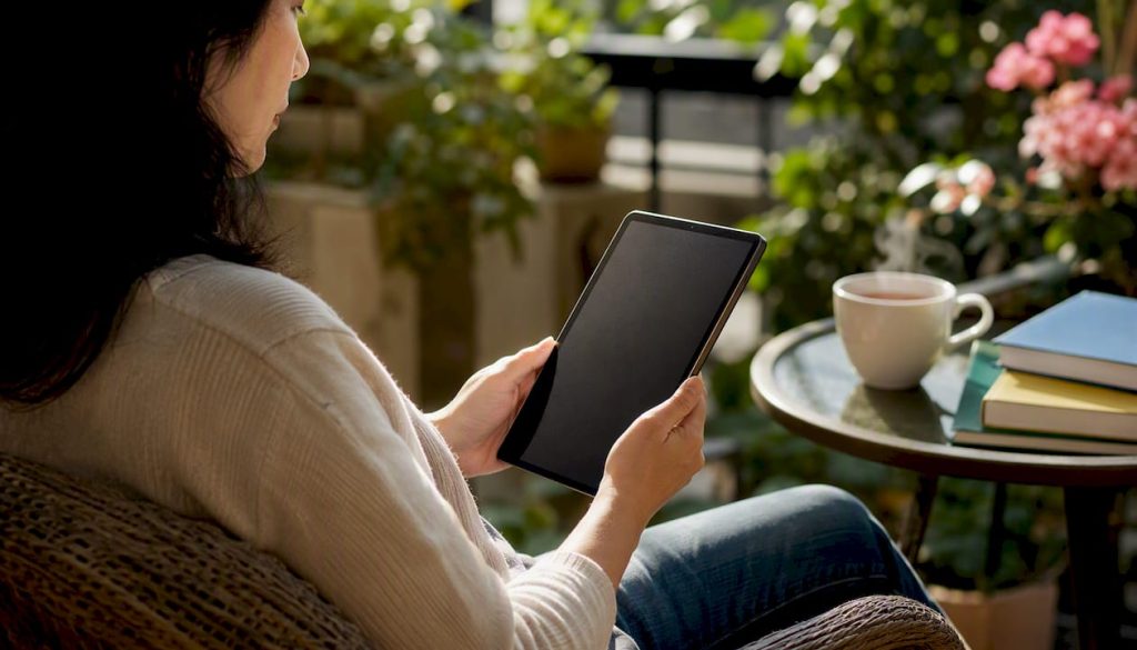 Adult reading Mandarin on tablet at desk