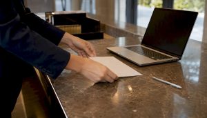 Hands placing Mandarin cheat sheet on counter