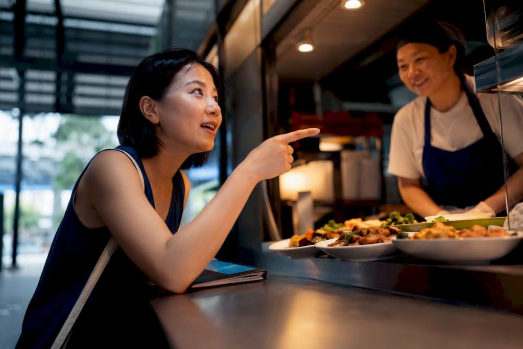 Learner speaking Mandarin at Singapore hawker centre
