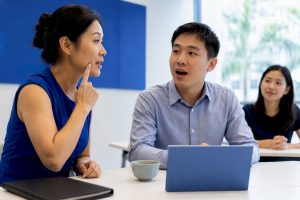 Instructor correcting professional Mandarin learner