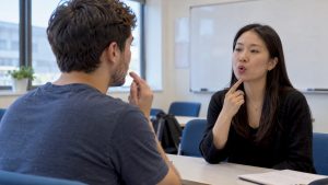 Adult learner practising Mandarin pronunciation with instructor