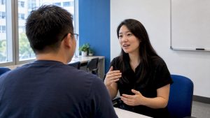 Adult learner practising Mandarin greeting in class