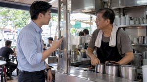 Adult learner practices Mandarin at a coffee stall