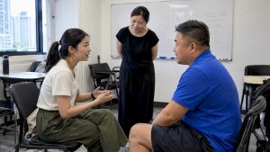 Adults practicing Mandarin conversation in class