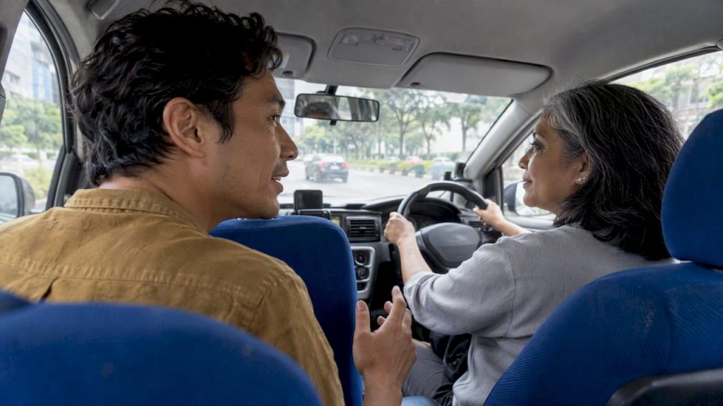 Adult practising Mandarin with a taxi driver